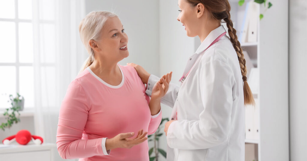 woman discussing hormone therapy for menopause symptoms with healthcare provider