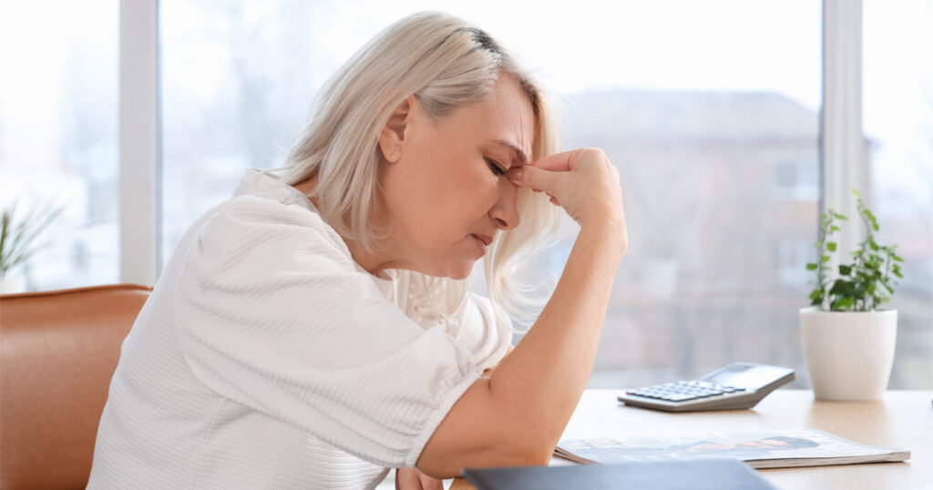 Woman experiencing perimenopause symptoms including fatigue and mood changes