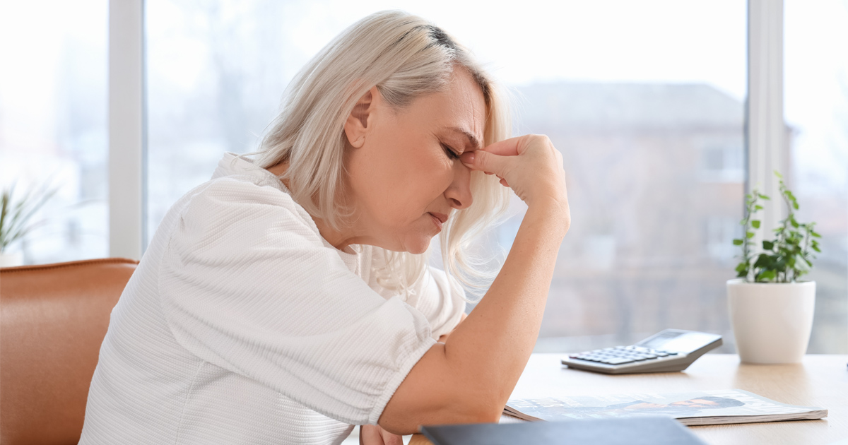 Woman experiencing perimenopause symptoms including fatigue and mood changes